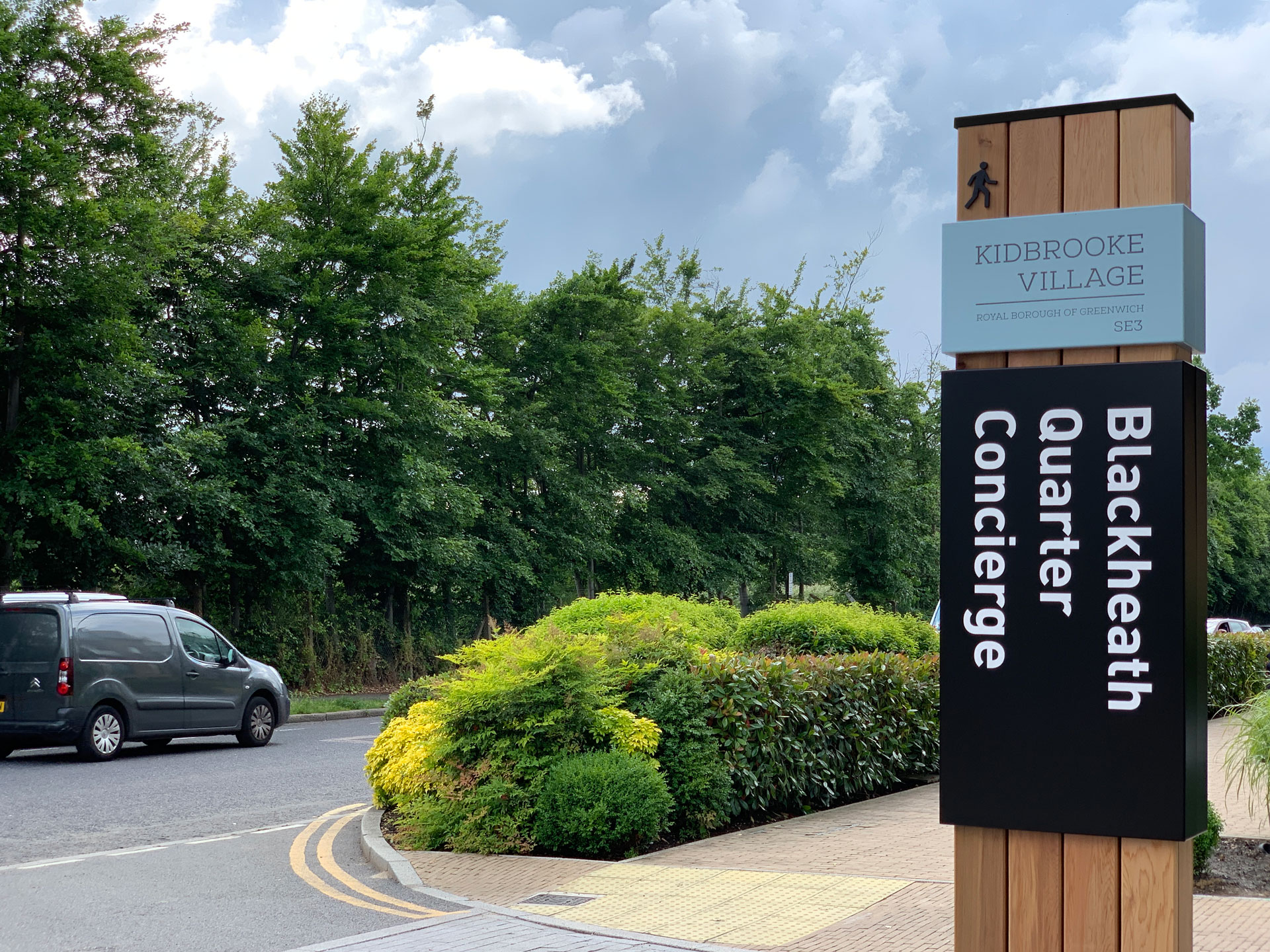 Community wayfinding signage connecting residential and retail zones — Kidbrooke Village, London, Air Design
