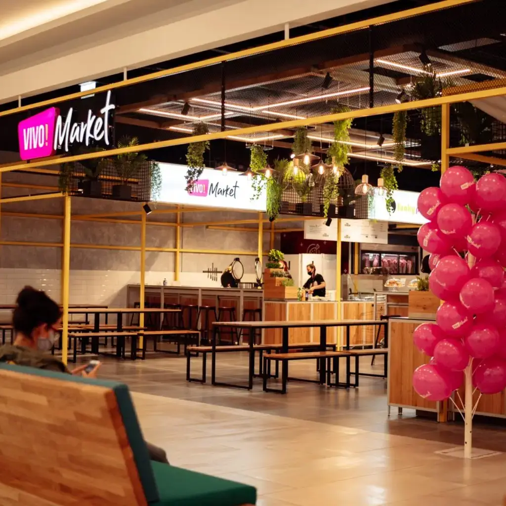 Steel modular units at VIVO! Market retail concept Biophilic design with high-level planting at VIVO! Market Interior of VIVO! Market retail concept featuring local food stalls