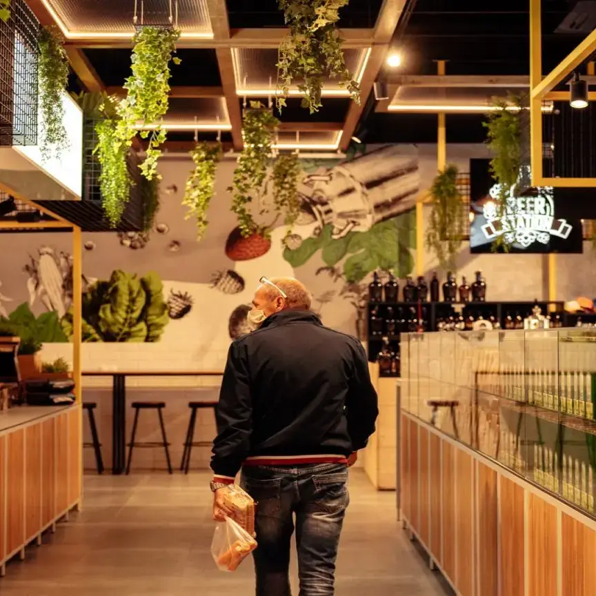 Steel modular units at VIVO! Market retail concept Biophilic design with high-level planting at VIVO! Market Interior of VIVO! Market retail concept featuring local food stalls